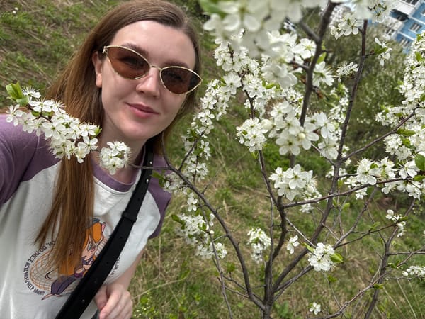 Woman enjoys spring blossoms in Izhevsk park setting