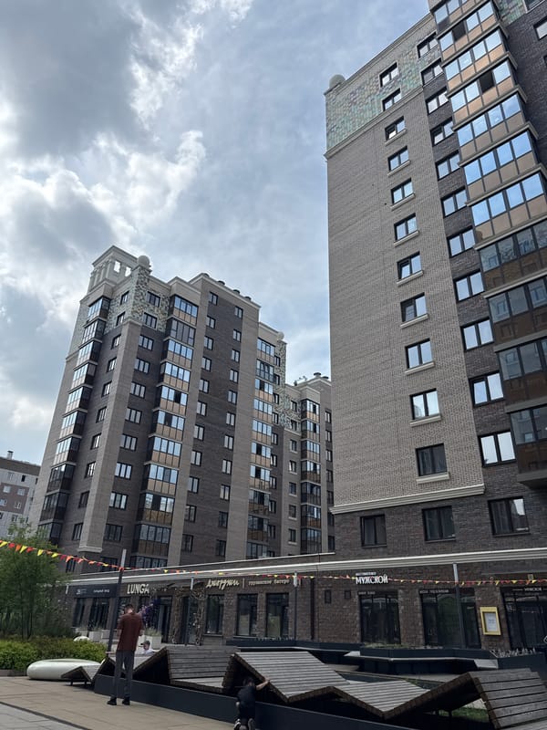 Morning street photography captures modern Krasnoyarsk apartment buildings