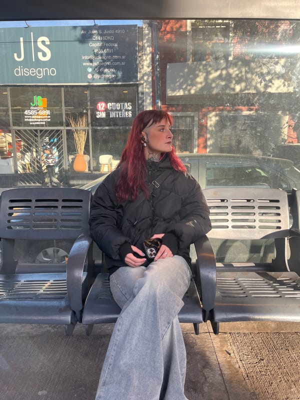 Woman waits at Buenos Aires bus stop Sunday evening