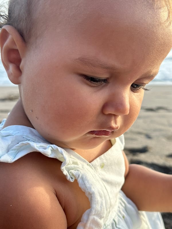 Baby and dog on a North Kuta beach morning