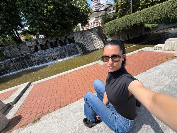 Woman takes selfies in outdoor Pleven square, Bulgaria
