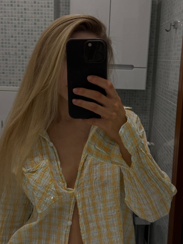 Mirror selfie in a Moscow bathroom, glittery plaid shirt