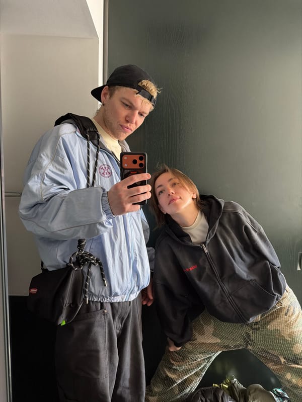 Couple takes selfie in cone-lined hallway in Chuo