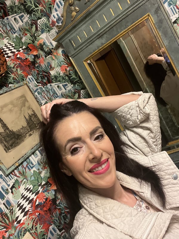 Woman in quilted jacket observed in decorated indoor spaces