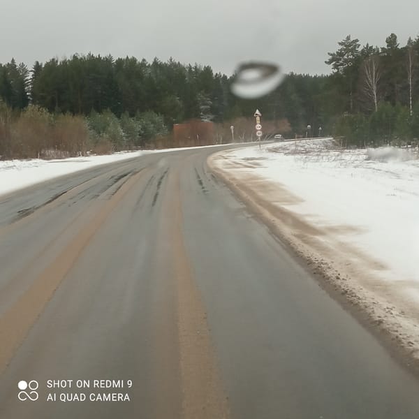 Snowy road conditions documented in Прикамский, Russia
