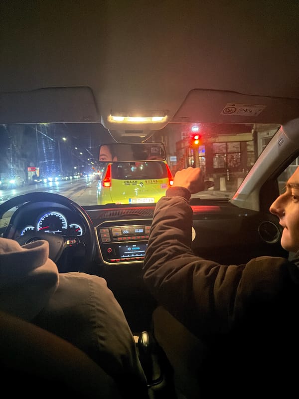 Driver gives thumbs-up during nighttime car ride in Sofia