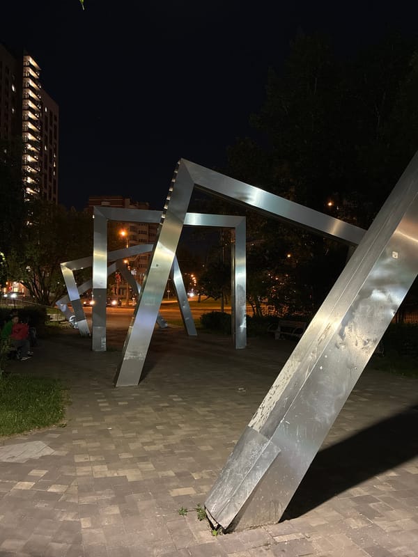 Illuminated metal sculpture installation documented in nighttime Moscow