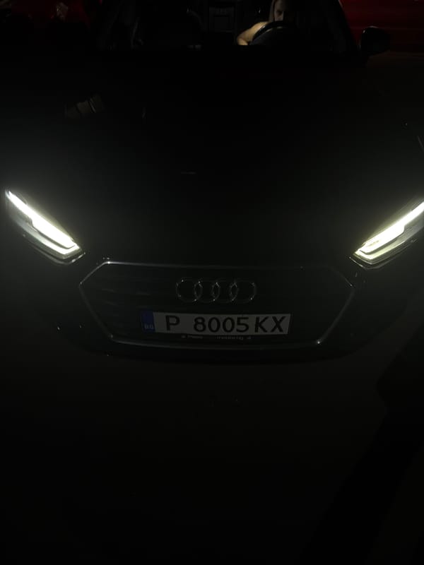 Person switches between luxury cars in Bulgarian parking lot