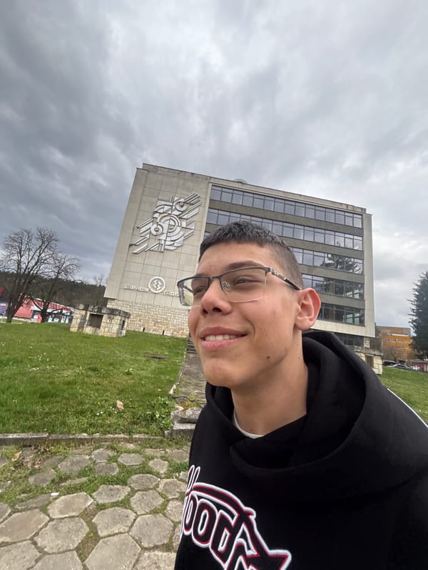 Young man takes selfies outside building in Troyan, Bulgaria