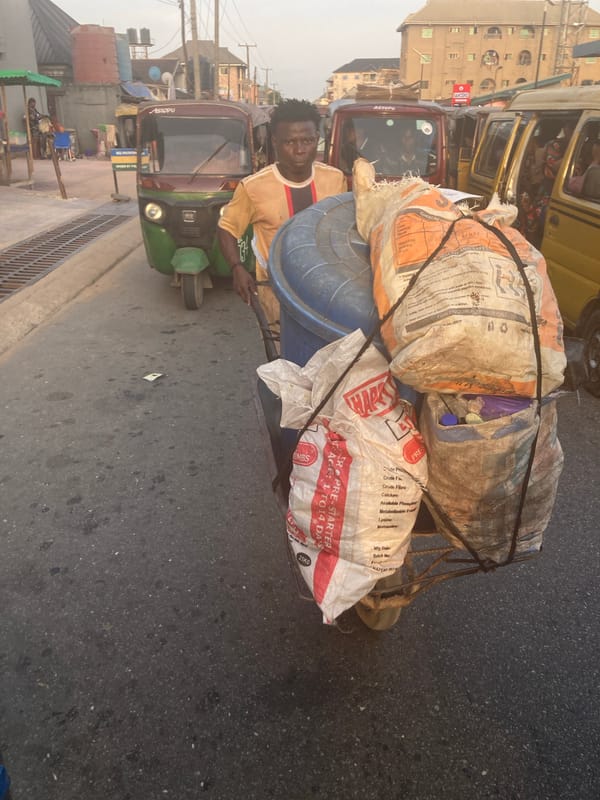Daily life unfolds on Umuode streets during sunset hour