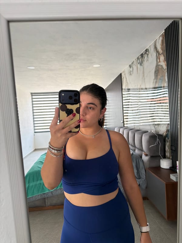 Woman documents evening routine with selfies, pet in Puebla bedroom
