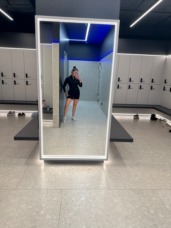 Woman takes mirror selfie in Russian gym locker room