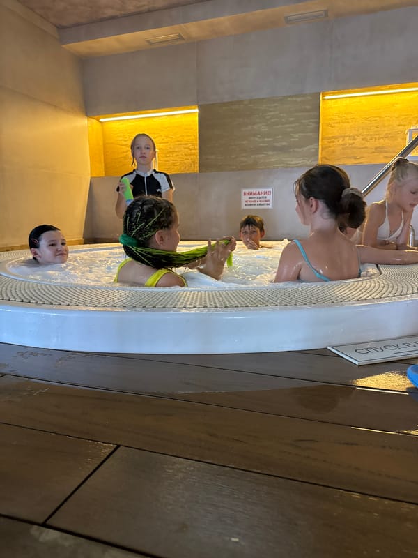 Kids and guests enjoying an indoor pool facility in Yevpatoriya