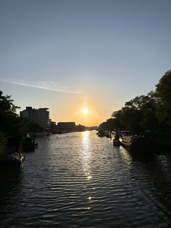 Golden hour on an Amsterdam canal, bikes and houseboats