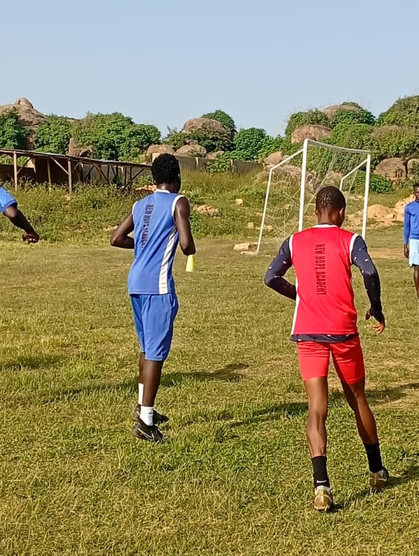 Soccer training session on a Jos pitch, New Hope Academy kit