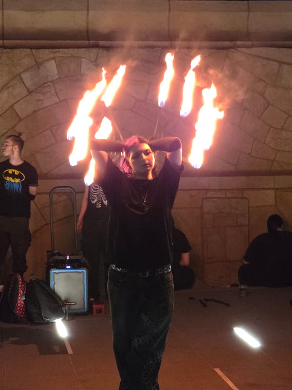 Fire performers light up a Warsaw plaza on a summer night