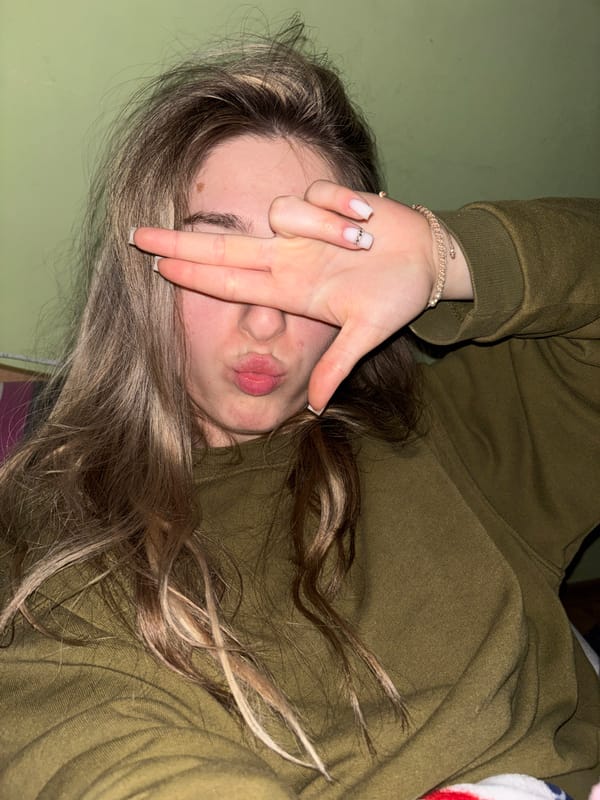 Person resting with decorated nails observed in casual moment