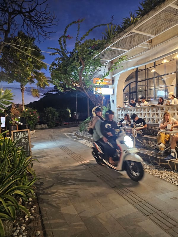 Full moon rises over Sanur Beach as dusk crowds gather