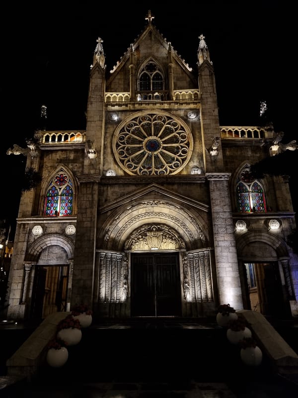 Gothic stone church facade lit up at night