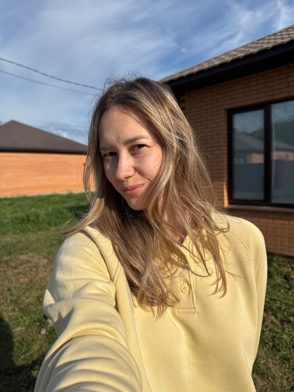 Woman photographed smiling outside brick building in Chaikovsky, Russia
