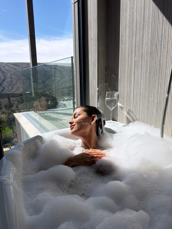 Morning bubble bath with mountain views captured in Tbilisi