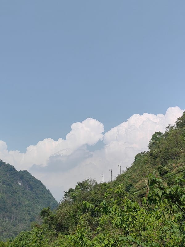 Mountain landscape with power lines captured in Vietnamese commune