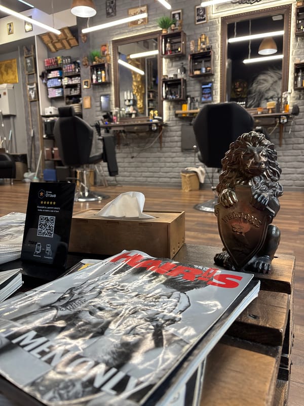 Minsk barbershop interior observed with lion statuette, magazines