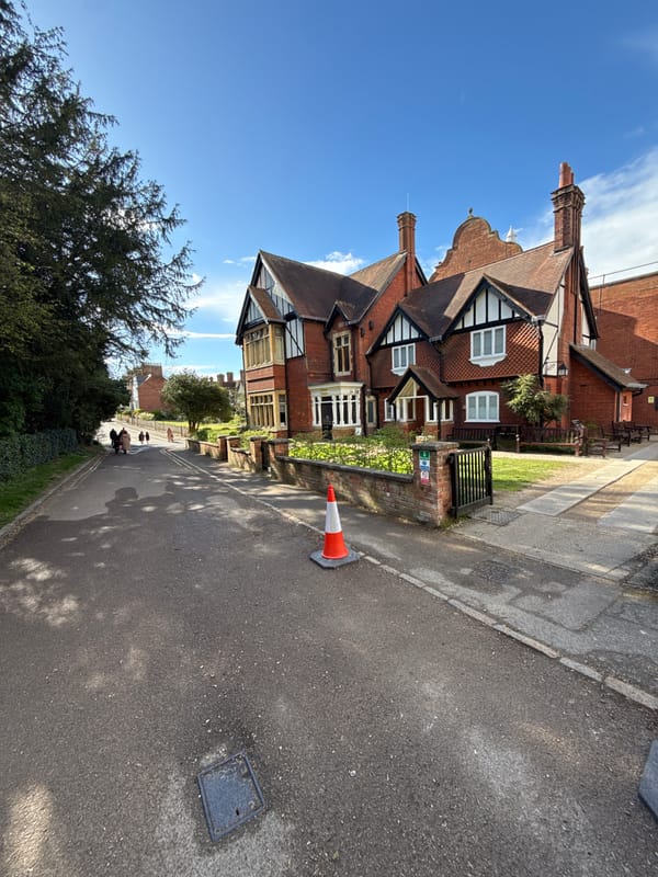 Tourist documents Tudor architecture during Berkhamsted town center stroll