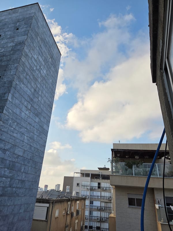 Street-level buildings and a YouTube browse session in Rishon LeZion