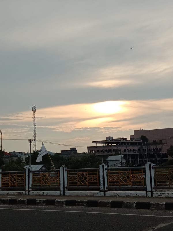 Bridge observer documents evening traffic in Lhokseumawe, Indonesia