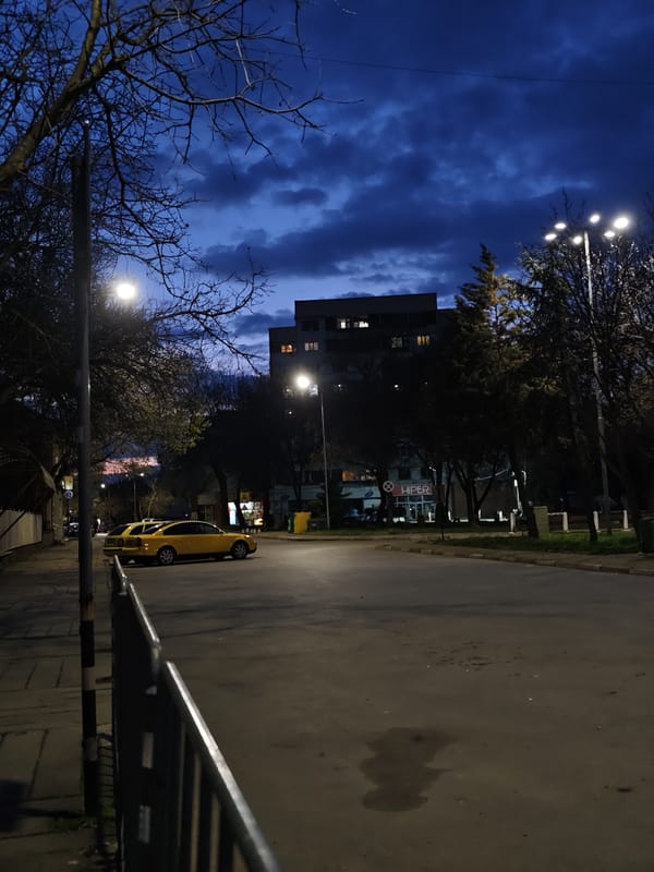 Evening street scene with parked cars in Kozloduy Bulgaria