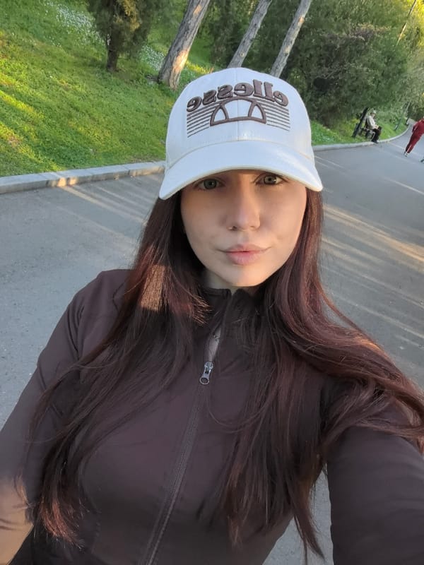 Woman takes selfies while strolling with stroller in Bulgarian park
