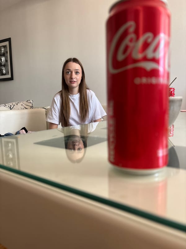 Woman enjoys afternoon snacks and Coca-Cola in Kragujevac cafe