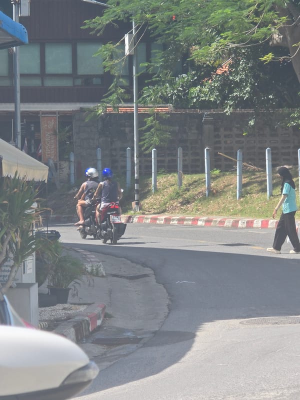 Tropical street life: scooters, trucks, and sidewalk scenes midmorning