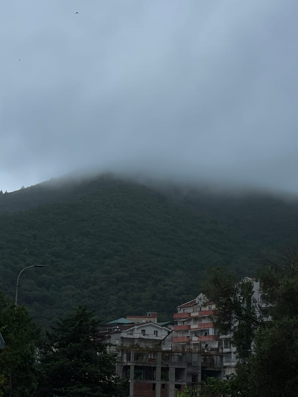 Foggy mountain landscape with buildings observed Saturday morning