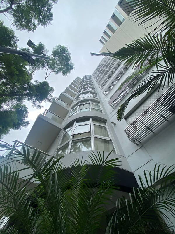 Curved tower photographed against cloudy sky in Buenos Aires