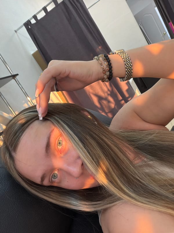 Woman checks phone indoors, car gets washed in Chaikovsky