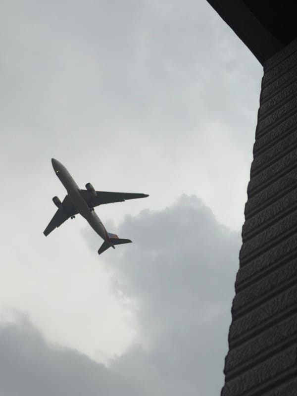 Planes over Delhi and a rainy rooftop view of Qutub Minar