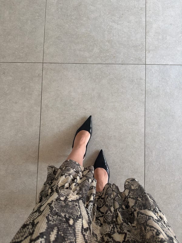 Person in heels, snakeskin dress spotted on tiled floor