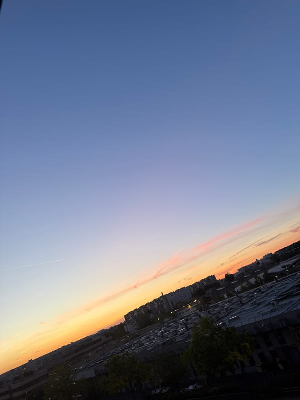 City twilight to night transition with distant firework displays