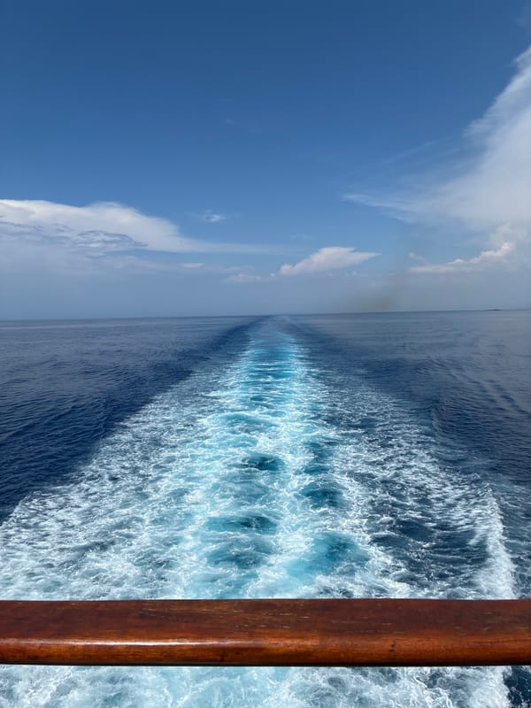 Boat wake cutting through blue Ionian water near Kafkalida