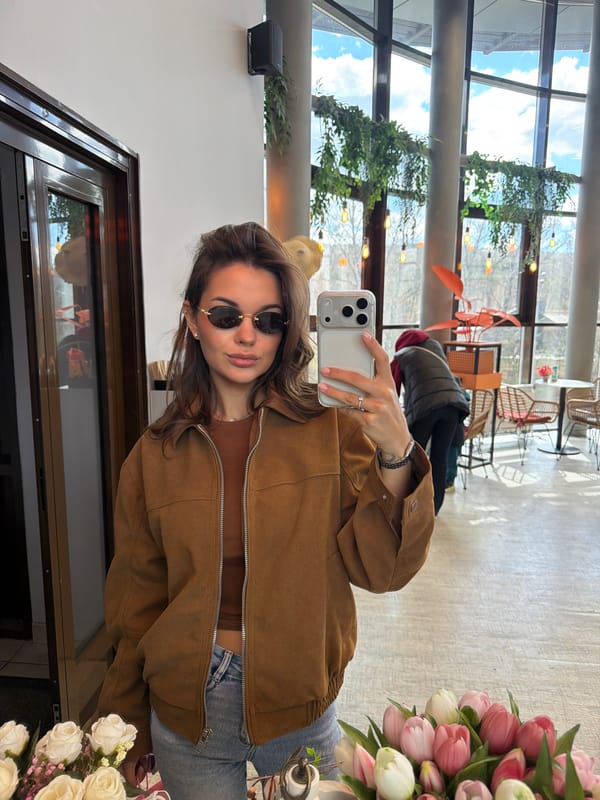 Woman takes selfies indoors in Krasnoyarsk cafe