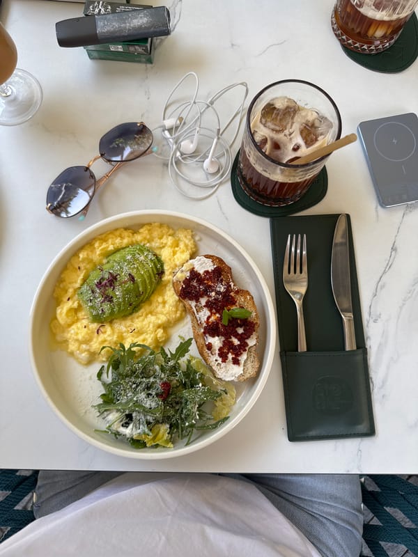 Morning table scene in Yerevan: breakfast, sunglasses, and headset