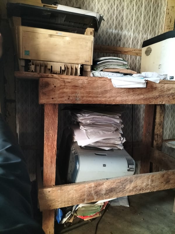 Cluttered workspace with office equipment documented in Jalingo, Nigeria