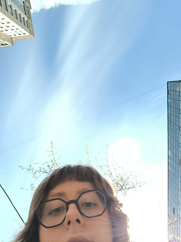 Person enjoys spring blossoms under clear Moscow skies