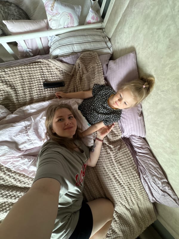 Mother and child share quiet morning moment in Russian village