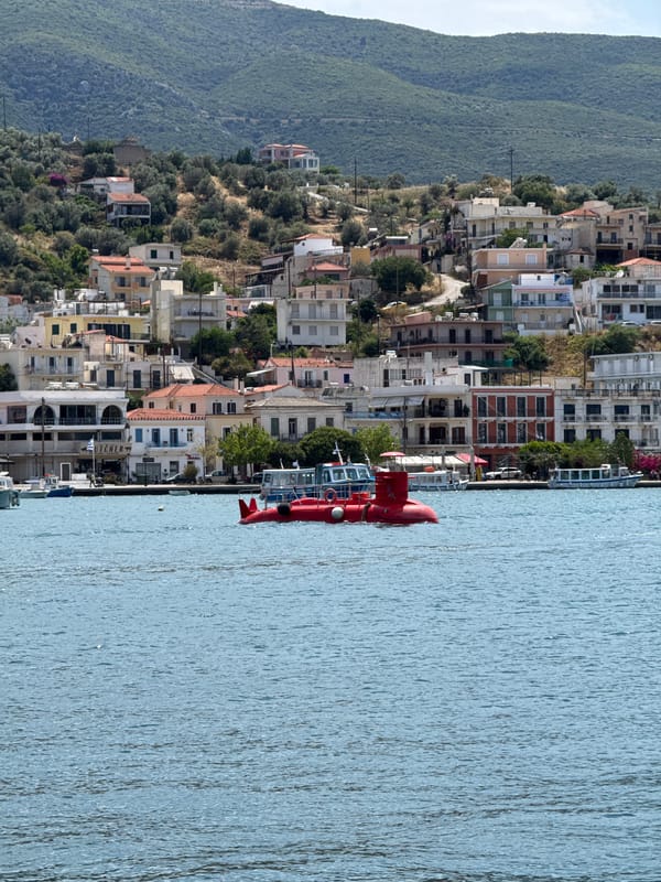Tourists and locals enjoy typical morning activities in Poros, Greece