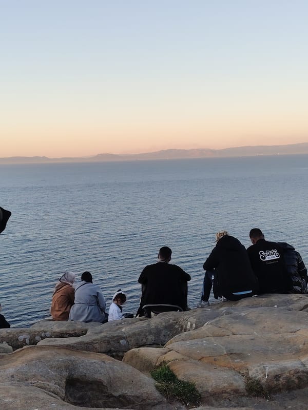 Group gathers on rocky outcrop overlooking Strait of Gibraltar
