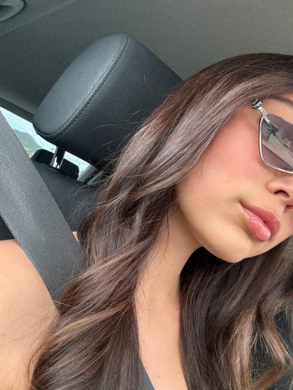 Woman observed as car passenger wearing sunglasses
