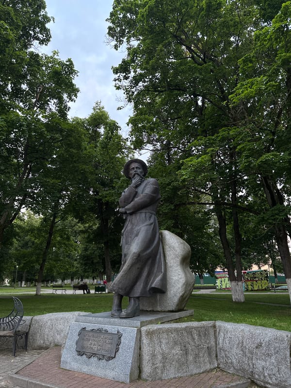 Smarhon's Bahuševič statue and Holy Trinity Church at dusk